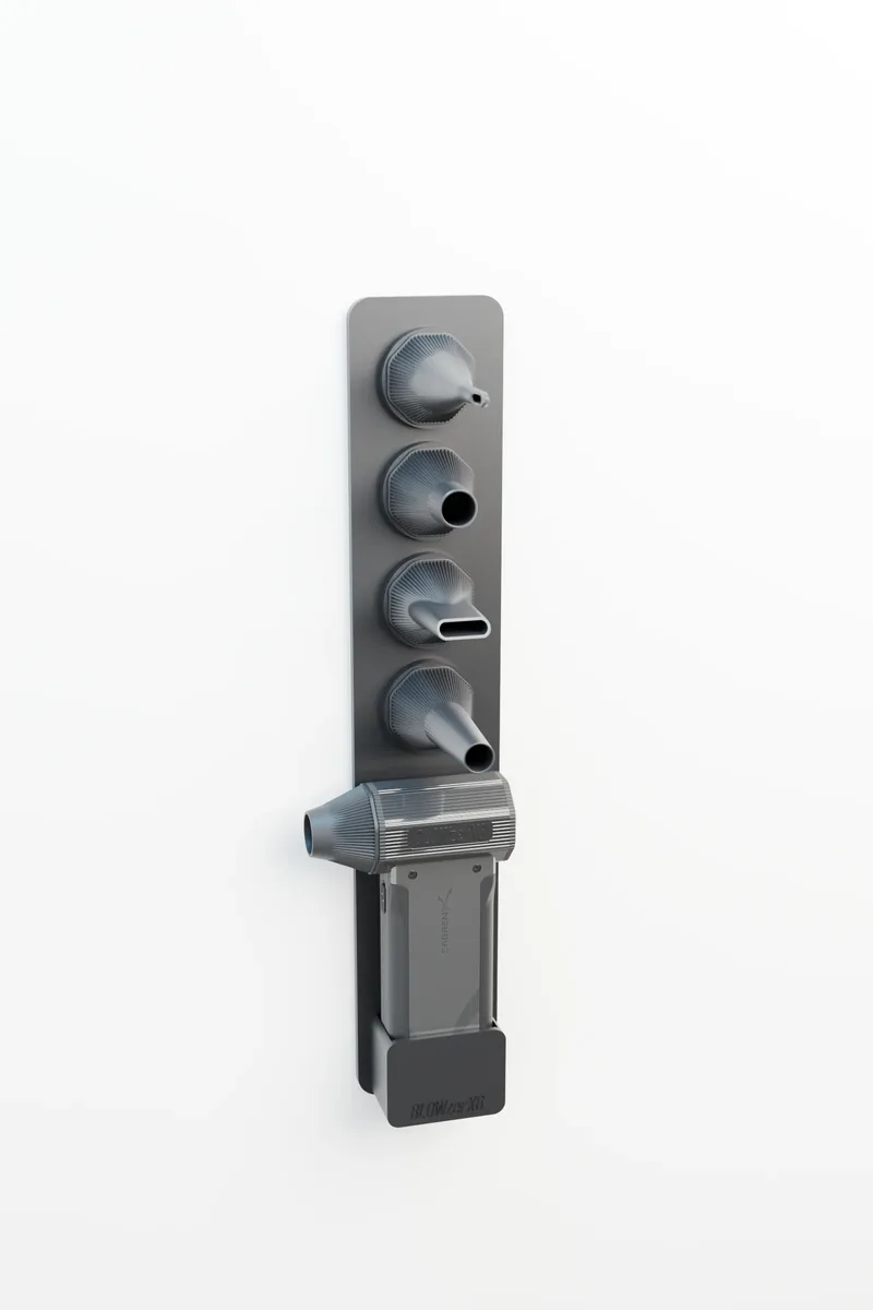 BLOWZER X6 hanging in the wall column, four spare nozzles twist-locked in a stack above it