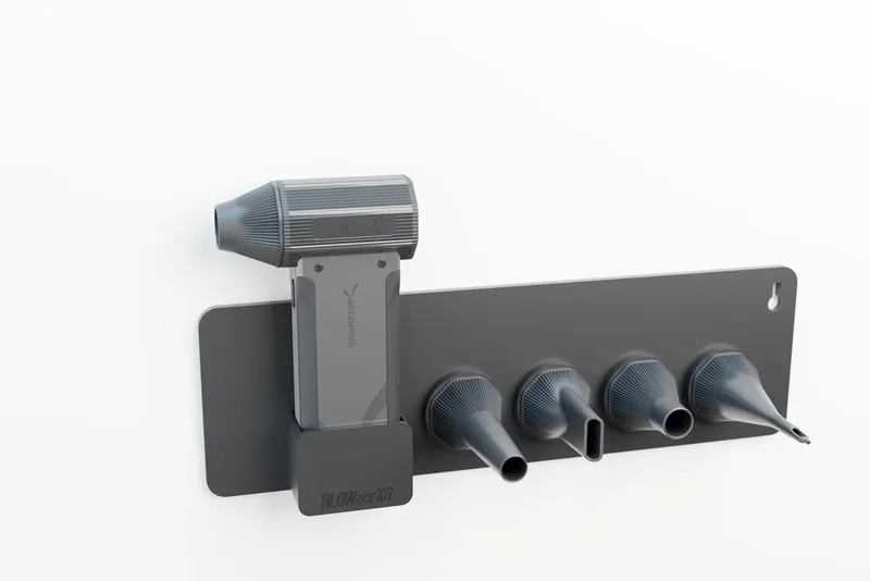 BLOWZER X6 hanging in the wall rail, four spare nozzles twist-locked in a row beside it